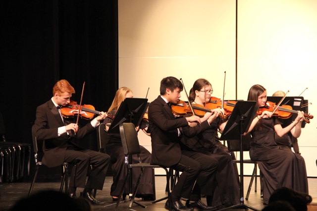 Orchestra students play in front of an audience.  Photo credit Alanna Wilde.