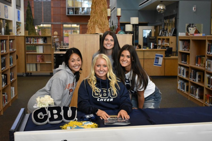 McKina and supporters pose for pictures throughout signing. She is gearing up for her final year as a wildcat before she heads off to be a lancer.
