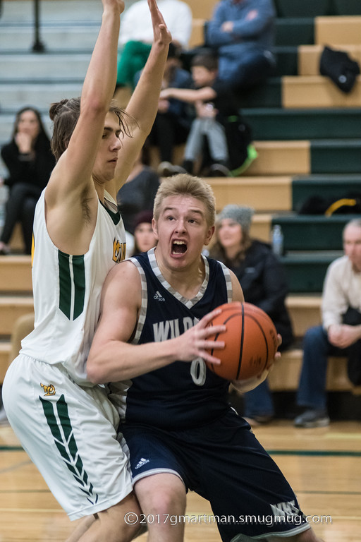 Zach Rosetti charges the basket.  The cats played hard but fell to West Linn.