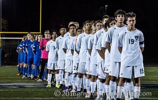 The boys soccer team lines up for the national anthem before facing off against La Salle.