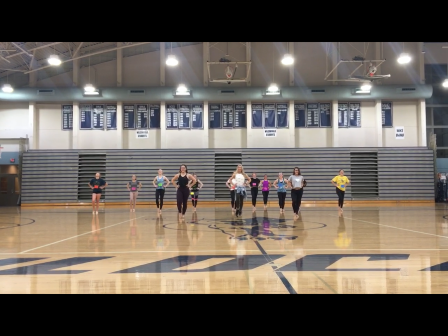 Dancers and one of the coaches  in the beginning of preforming tryout routine. 
