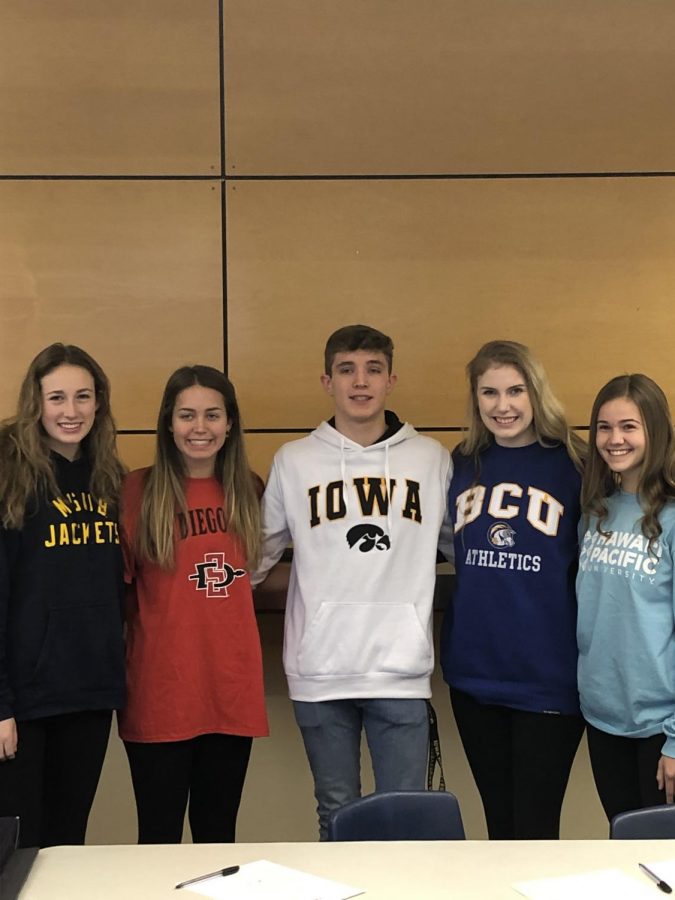 Kennedy Juranek,
Brooklyn Waddell, Zach Tiderman, Paige Hinnant, and Julia Huchler pose for a picture after signing their athletic scholarships. Photo credit Emilia Bishop.