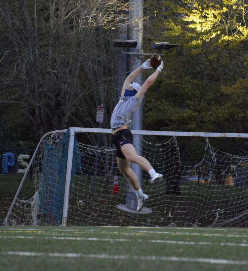  Kellen Hartford, a junior at Wilsonville High School, seen catching a football, masked up on the field.
Photo belongs Ava Stenstrom.
