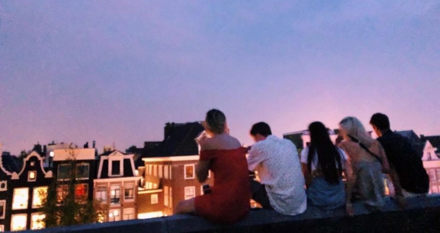 Taryn Lamb and friends  sitting on a rooftop enjoying a beautiful summer sunset in London. Some of Lambs favorite memories from Studying Abroad were nights like this out on the town. 