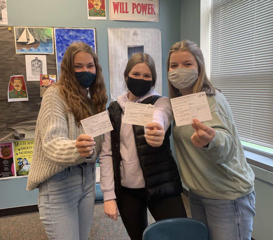 Three WBN students showing off their vaccine cards!