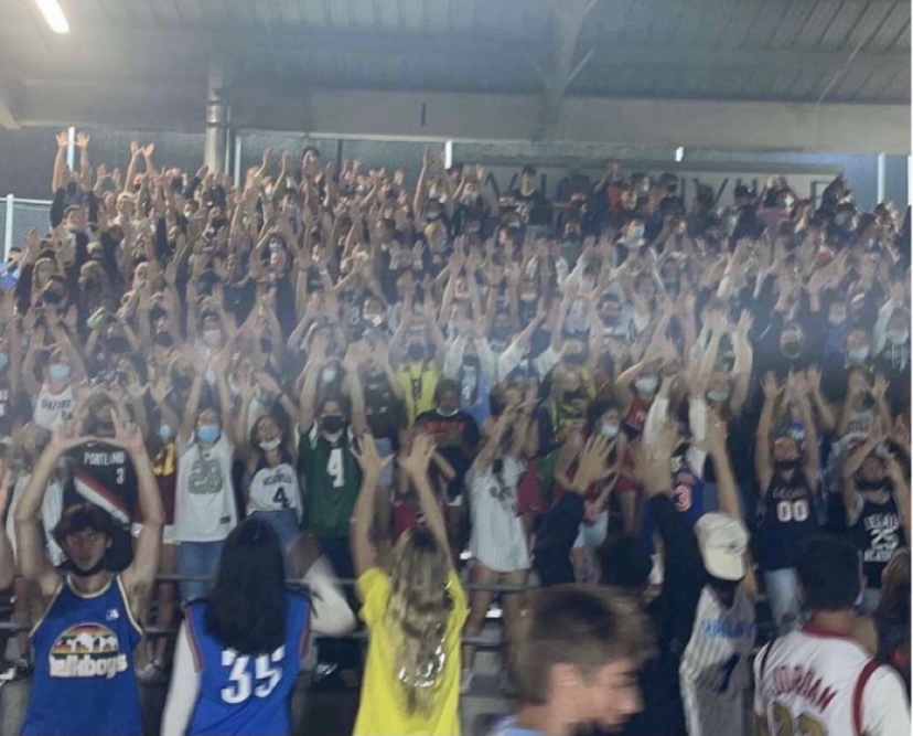 The student section holding up Ws during the Boys Varsity football game against Lebanon. 