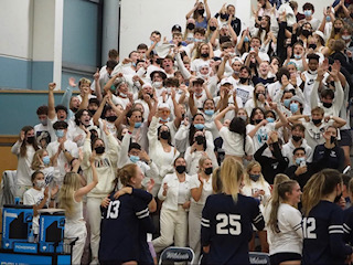 The student section cheers for their volleyball team.