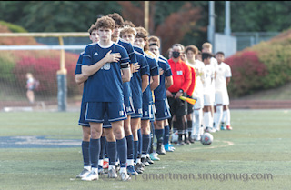 The Boys Soccer team standing for the National Anthem