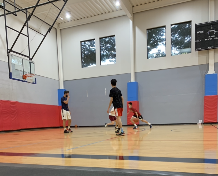 Yok Nuntipak partakes in a two-on-two game with junior Maxim Wu as his teammate. The boys won the half-court game by a small margin, and both were instrumental in the win.
