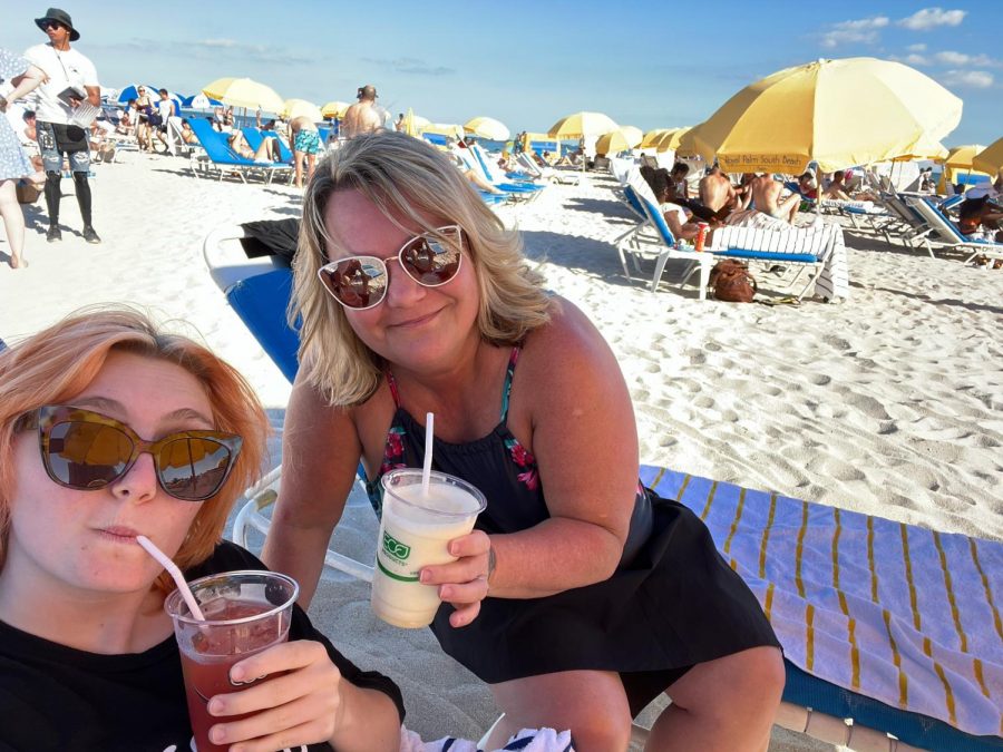 Emma and her mom posing for a picture on Miami beach with refreshing drinks in their hands. Their full day was spent relaxing in the sun!