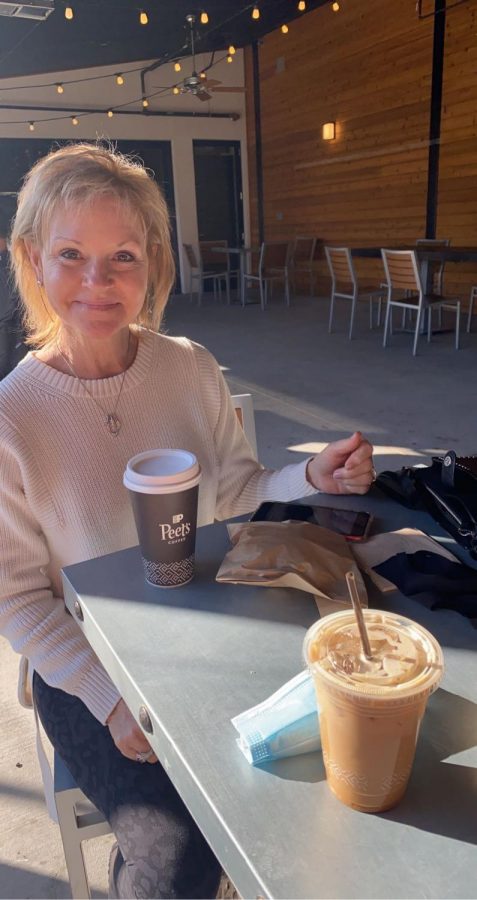 Kathy Bierma and the author enjoying a cup of coffee together and replying to emails. The outdoor seating area has around 10 tables all evenly spread out and patio heaters!