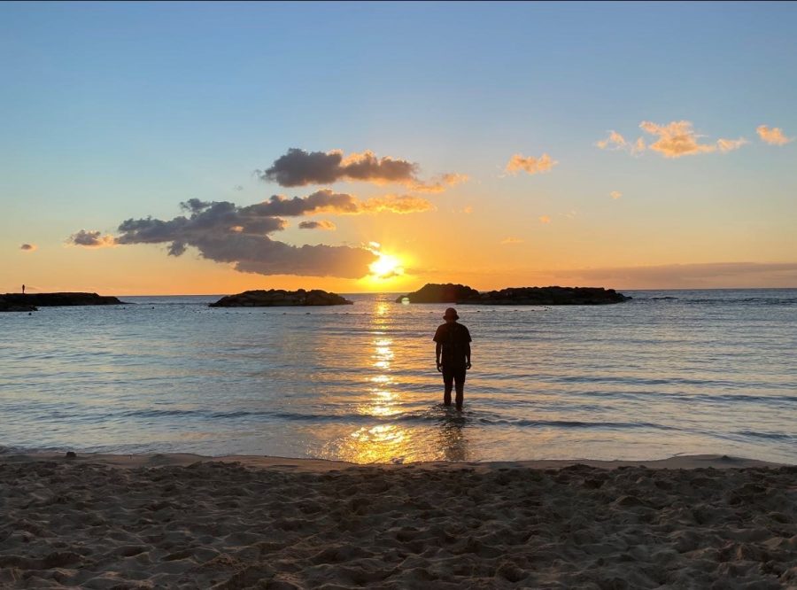 A photo capturing Ryland Espejo looking off into the sunset. It was taken at one of the many beaches surrounding the area.