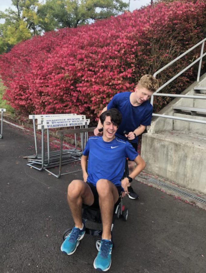 Senior Ben McClelland pushing sophomore Connor Larsen in an abandoned stroller in some post run shenanigans.