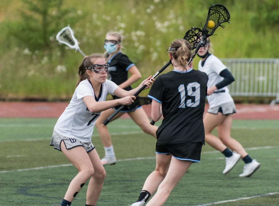 Katelyn LeBlanc defends Samantha Brown, an attacker from Mountainside, during the Cats final game of the 2021 season. LeBlanc played primarily defense for the Cats, alongside Bailey Waddell, Lilli Wesse and Lily Gloss.