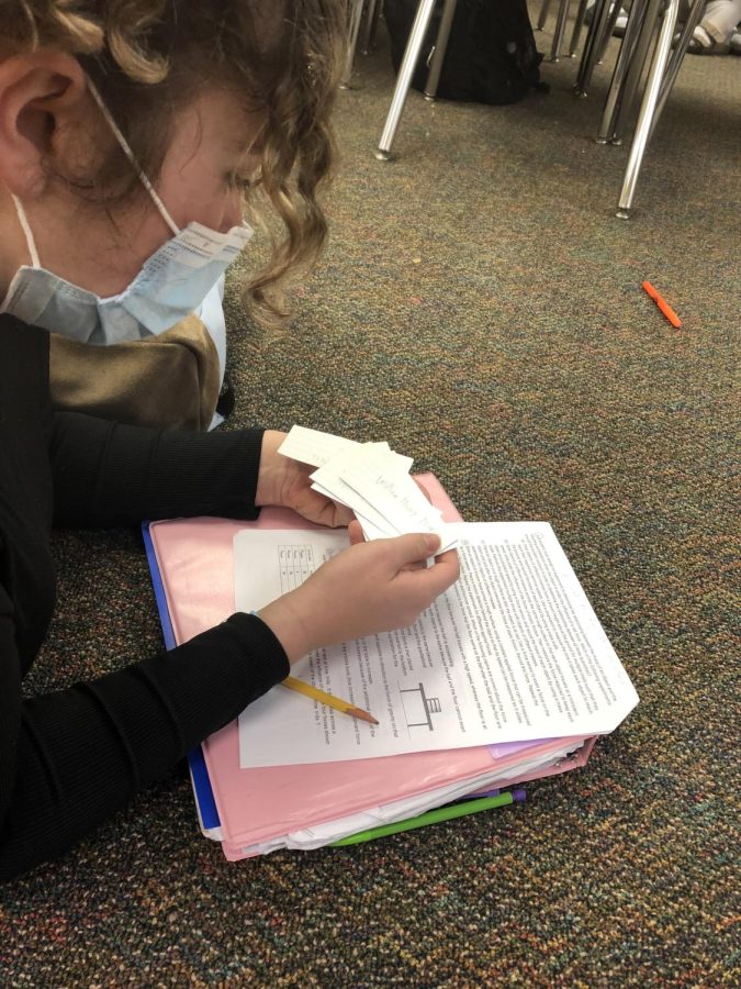Jasmine Brown preparing for her presidents test. She is studying flash cards that specify all of the important details she needs for the test. 