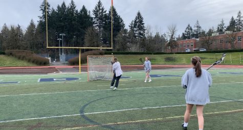 Katelyn LeBlanc (far right) and Grace Jenson (far left) help Audrey Counts learn how to shoot. Counts is a freshman and prospective first year player for the team this coming season. 