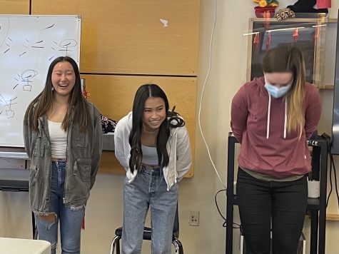 Chinese students perform a greeting ceremony at the beginning of class. This brings the class together in preparation of cultural presentations.