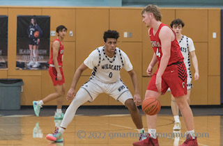 Junior Tristan Davis locking up a Central player. The Cats went on to win 47-34.