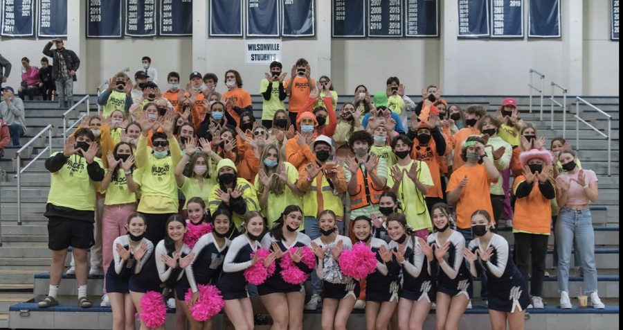 Wilsonvilles student section posing during the boys Varsity basketball playoffs against Central. The theme was neon out. Photo provided by Greg Artman.
