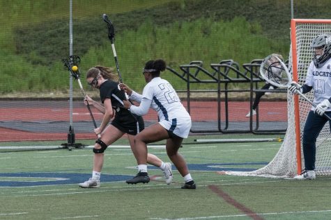 Lydia Harms defends a crease-roll during the Cats’ game against Clackamas. Harms is a versatile player for the Cats, as she plays defense, midfield, and attack.