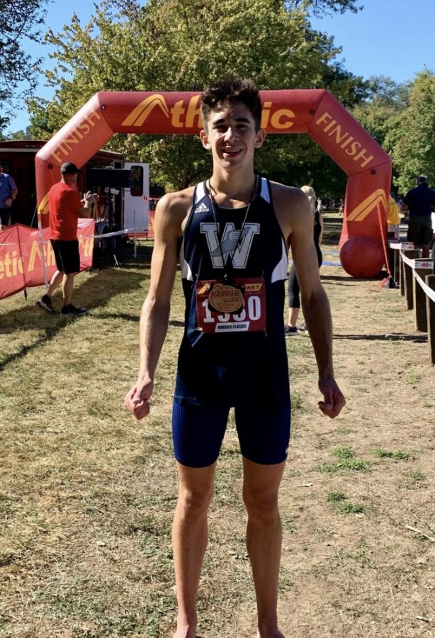 Carter Cutting stands in front of the finish line after placing first in the boys varsity division. This is Cuttings first season on the Wilsonville team after moving back to Oregon this past summer.