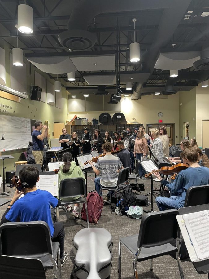 Cast and Orchestra work together on getting through a song during a dramatic scene in the musical. Cant wait to see on stage.