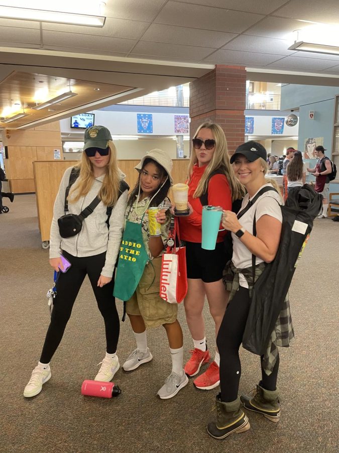 Sophomores Olivia Kundert, Kiera Easterly, 
 and junior Maddie Holly, along with teacher Sra. Zolotoff show off their BBQ Dad and Soccer Mom getup. 