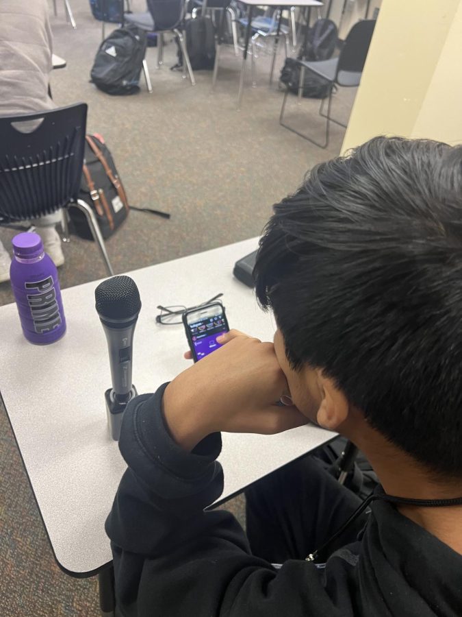Junior Hector Baltazar is pictured distracted by the temptations of technology.