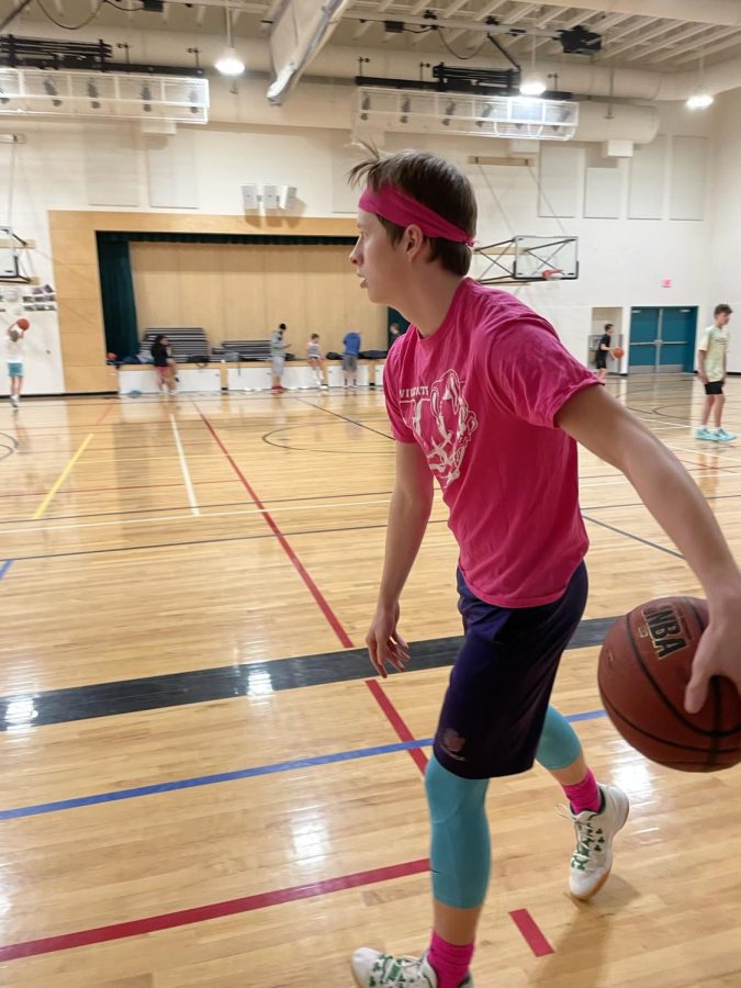 You may think Luke has a liking for pink. His headband, shirt, socks, and even the small logo on his shorts are pink. 