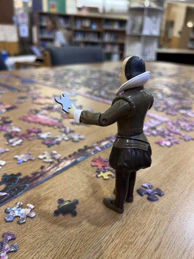 Shakespeare curiously connects the dots about where to place his puzzle pieces. He is one of many who works on the library puzzle every day.