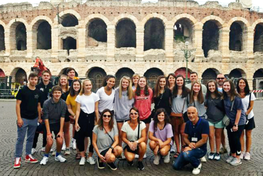 High-schoolers pose outside of the Colosseum. Photo exemplifying the greater nature of High School trips.