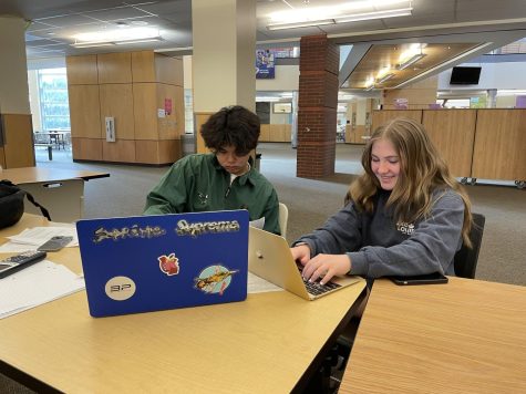 Paul Liu, Junior (left) and Abbie Memmott, Junior (right) work diligently on their position papers. They are excited for a great conference.