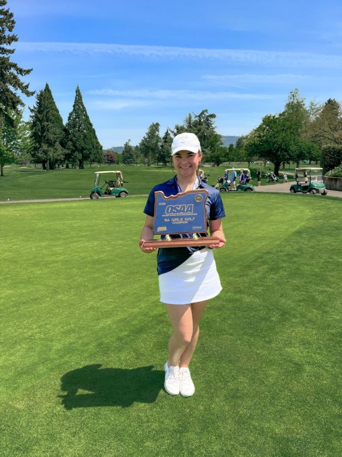 Malia Kaleikilo holds a trophy from when girls golf won state. Despite not having a large audience, sports like golf still take home titles!