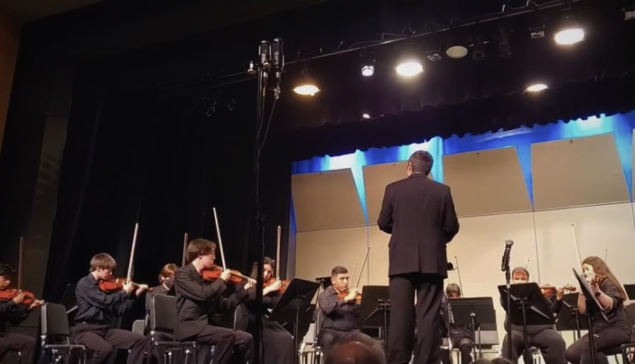 A close look at the string orchestra. We can see Mr. Daves conducting. He works hard and will continue to bring more amazing performances to come. 