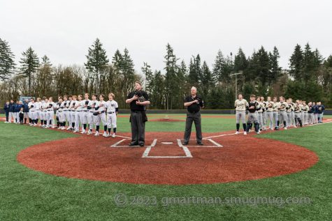 Wilsonville and Canbys Varsity teams stand for the national anthem. Wilsonvilles JV team faces Canby at home at 4:30 on Wednesday, May 3rd.