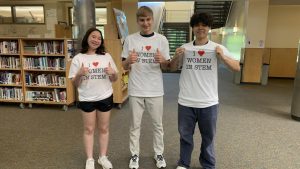 Anthea Goh is pictured with senior George Peykanu, center, and junior Paul Liu wearing her class t-shirts. While Peykanu and Liu are AP physics students (E&M and C, respectively), many other students have purchased these shirts. 