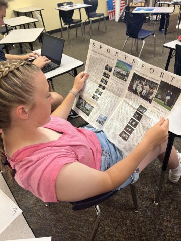 Maddie Holly relaxes and indulges in the newest edition of the Paw Print. She hopes to continue to pursue her love for reading during summer vacation.