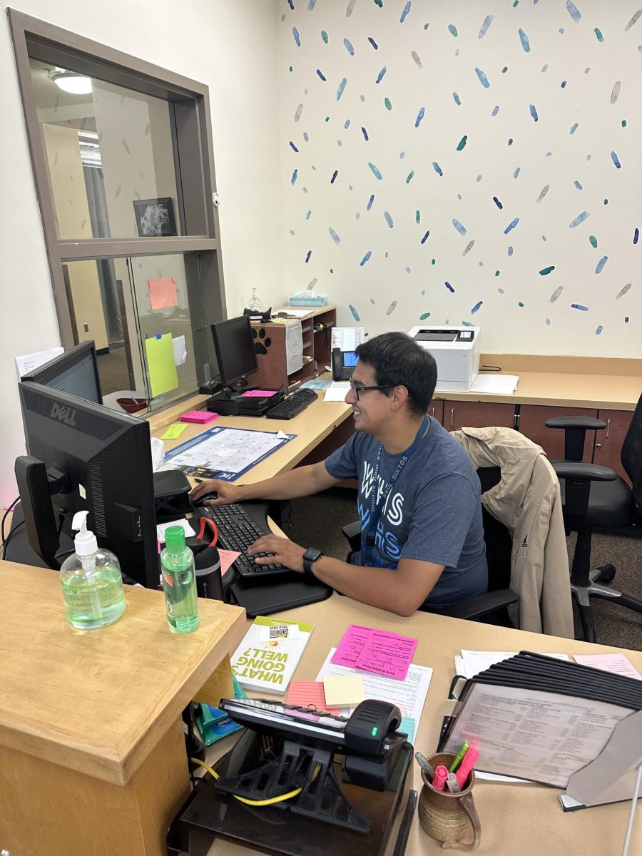 Mr. Sixtos working at his desk at Wilsonville High School.