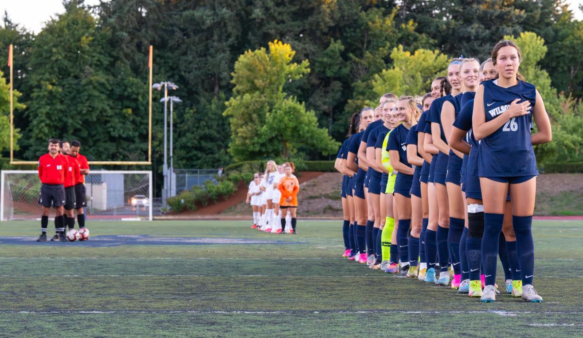Wilsonville+stands+for+pledge+of+allegiance+before+their+game.+The+Wildcats+went+on+to+win+this+match.+Photo+provided+by+Micheal+Williams.