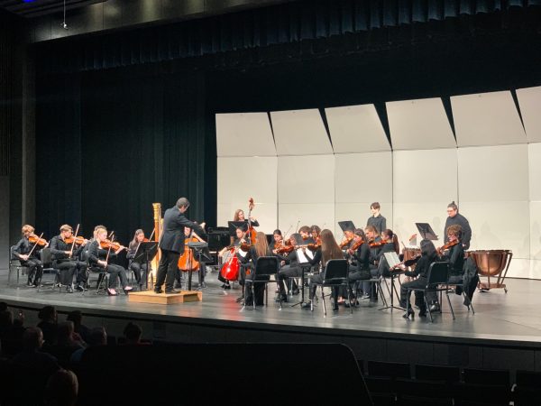 Mr. Davies conducts the orchestra. The performance was extremely successful and appreciated by the community.