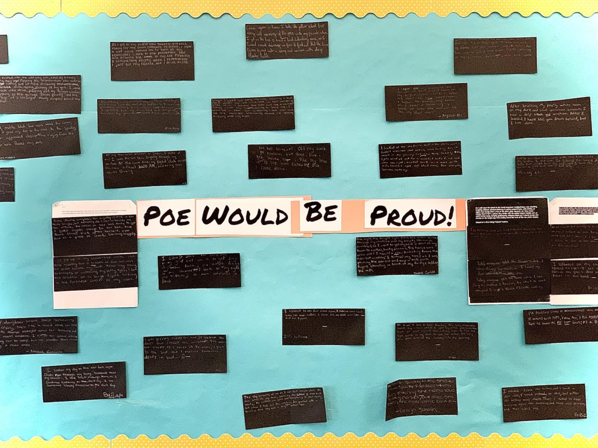 A collaborative wall in Mrs. Heatons classroom displays two-sentence stories written by students. These ideas were inspired by Edgar Allan Poes craft.
