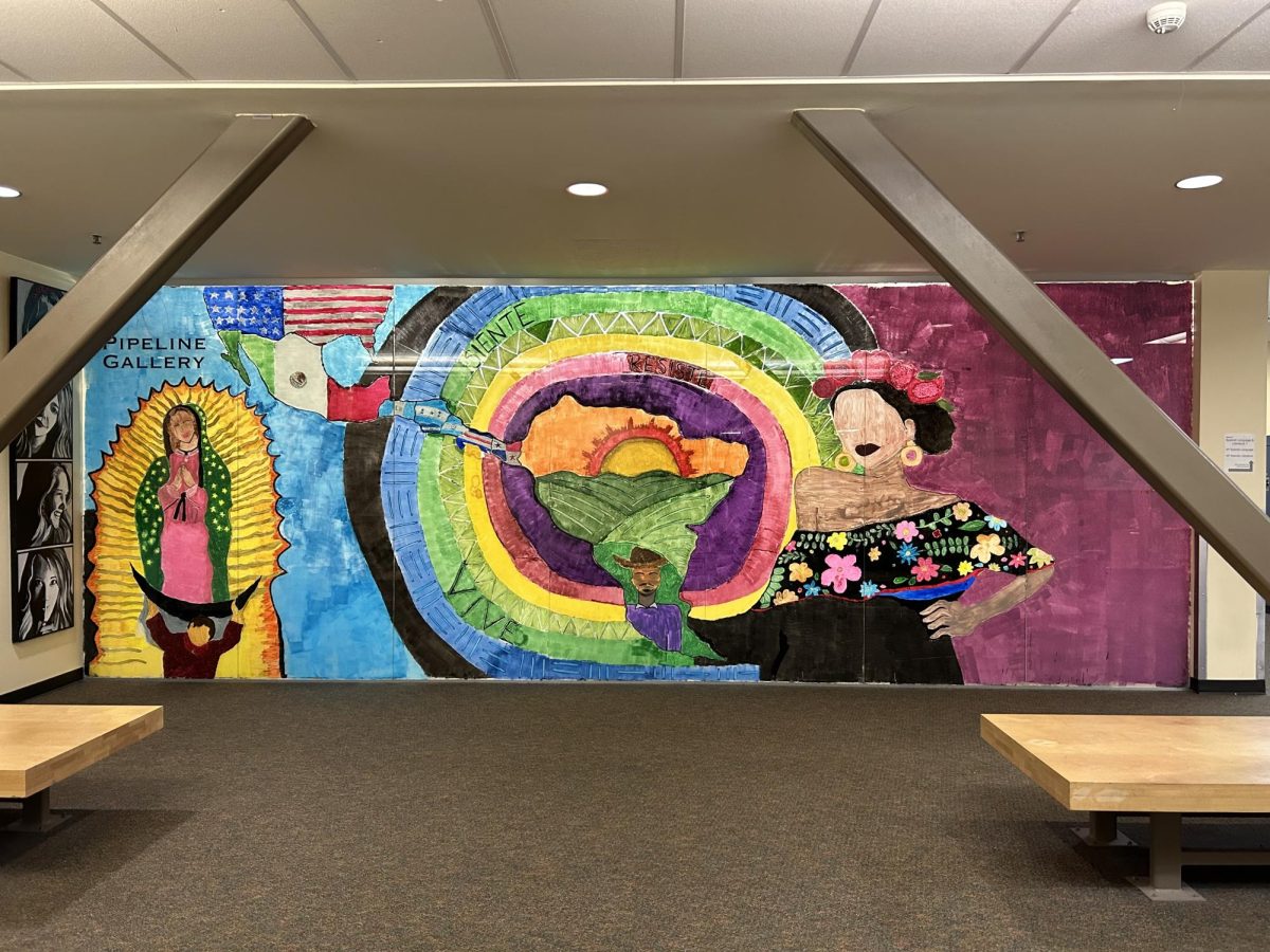 The beautiful mural displayed on the windows in front of room 81. The piece came to fruition after the hard work of many Latino Arts & Culture students.