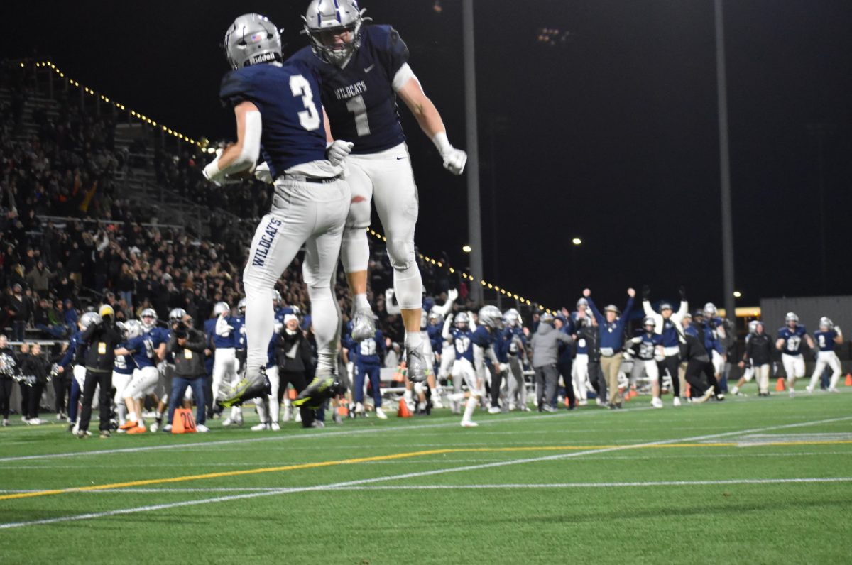 Mark Wiepert and Nick Crowley celebrate after scoring a touchdown to secure the lead as the team celebrates behind them. Wilsonville walked away with the first place title in the 2023 5A Football State Championship.