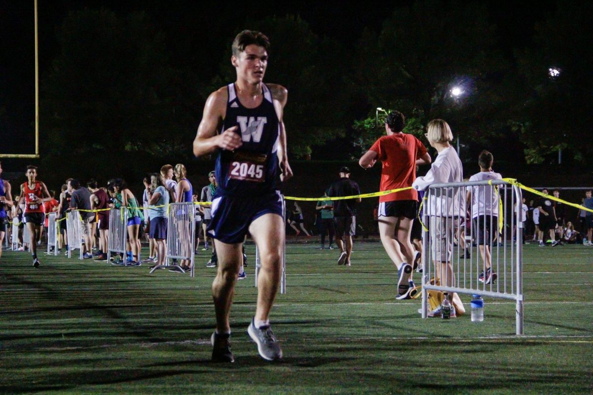 Wilsonville Cross Country team running in the night meet earlier in the fall. This was just the opener for a long and competitive XC season. Photo provided by the XC team.