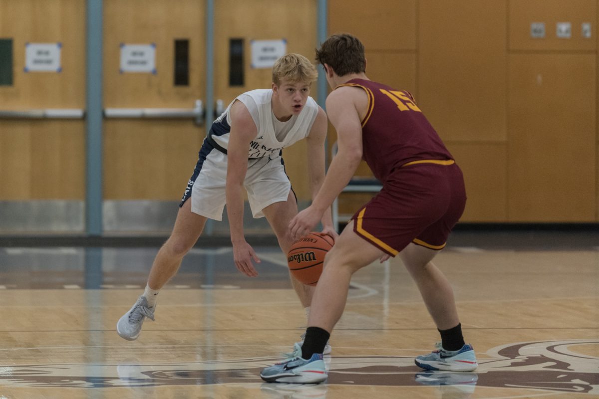 Sophomore Grady Weise guards #15 for Redmond High School. Wilsonville would go on to win the game 62-37. Photo provided by Greg Artman.
