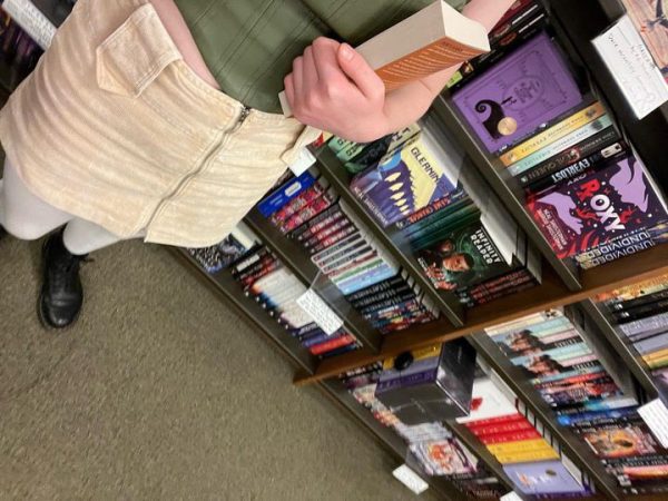 Taylor Nichols takes a beautiful photo in her natural habitat, Barnes and Nobles. She clutches onto her newfound treasure as she scans the walls for more written wonders.