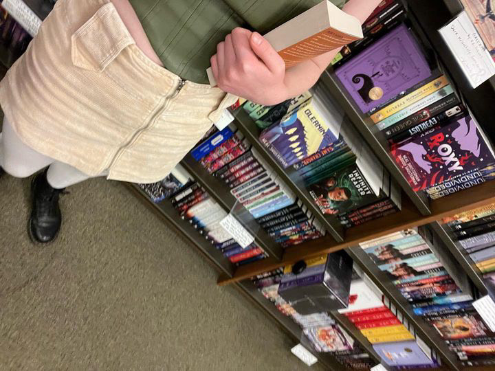 Taylor Nichols takes a beautiful photo in her natural habitat, Barnes and Nobles. She clutches onto her newfound treasure as she scans the walls for more written wonders.