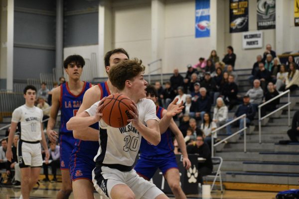 Jacob Boss catches a pass on the block, he finished with 17 points on the night. Boss helped propel Wilsonville to rousing overtime 68-58 win over conference rival La Salle.