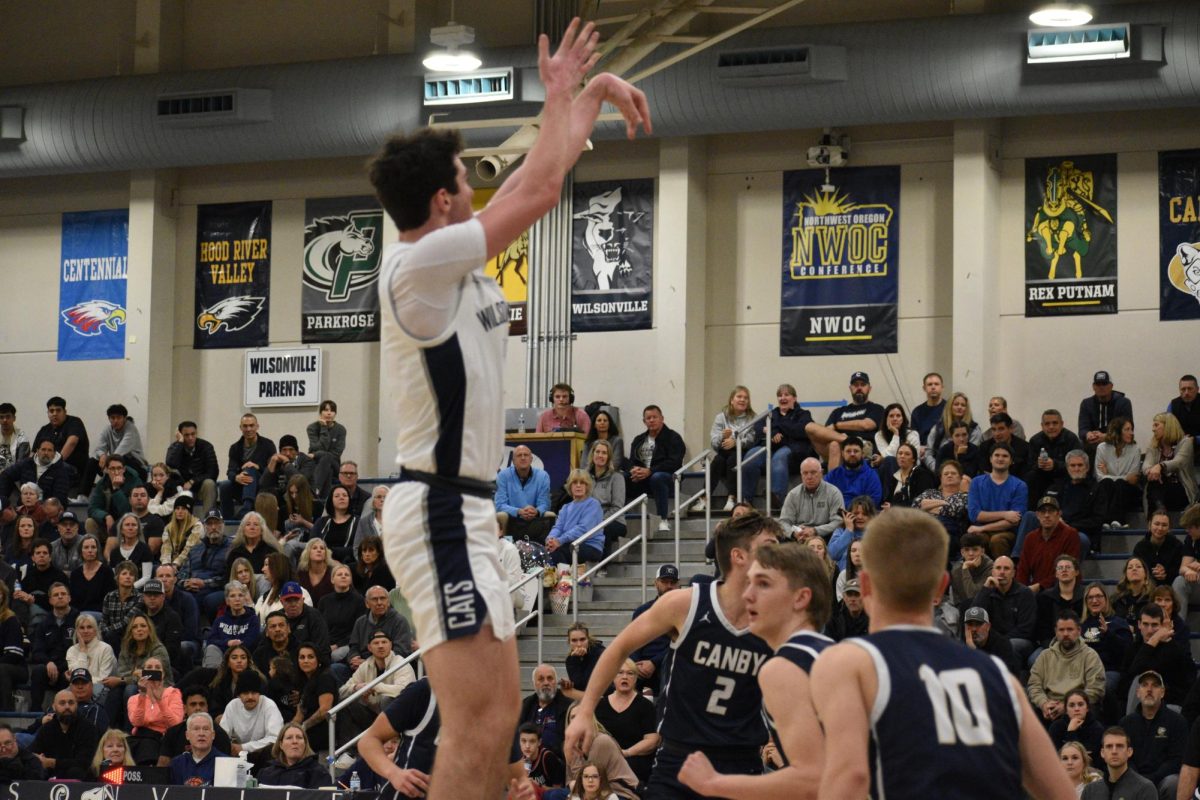 Kallen+Gutridge+elevates+to+sink+a+jumper+on+Senior+night+for+the+Wildcats.+Wilsonville+would+finish+their+regular+season+with+a+63-55+victory+over+Canby+to+improve+their+league+record+to+16-0.