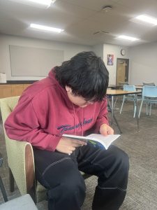 Senior, Axxel Zaragoza, reads his book, Frankenstein, in AP Literature. He later packed up his things and left for the day.